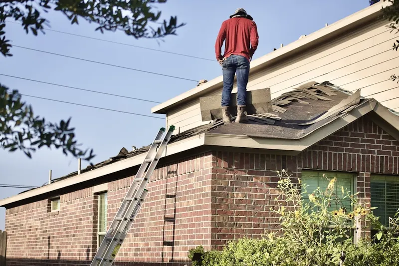 Professional roofer working on a residential roof in Sandston